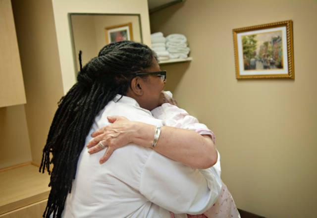 practitioner hugs patient