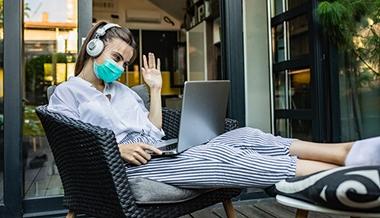 covid 19 prevention organ transplant - woman wearing mask using laptop
