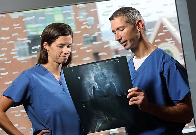 dr tis looks over an x ray with a nurse
